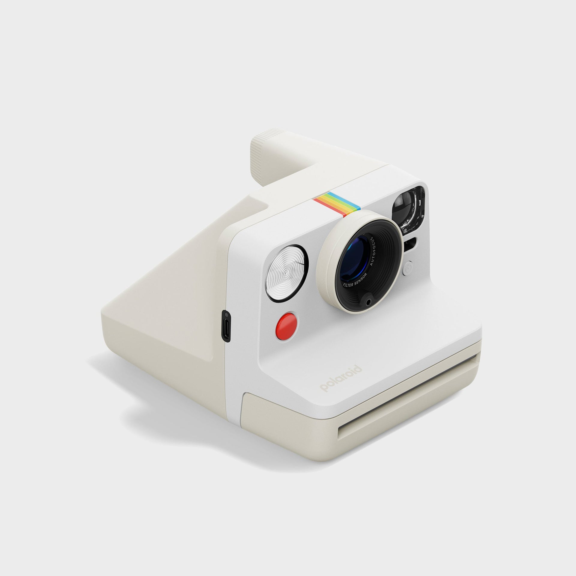 Polaroid Now Gen 3 pebble white instant camera at a three-quarter angle with USB-C port and red shutter