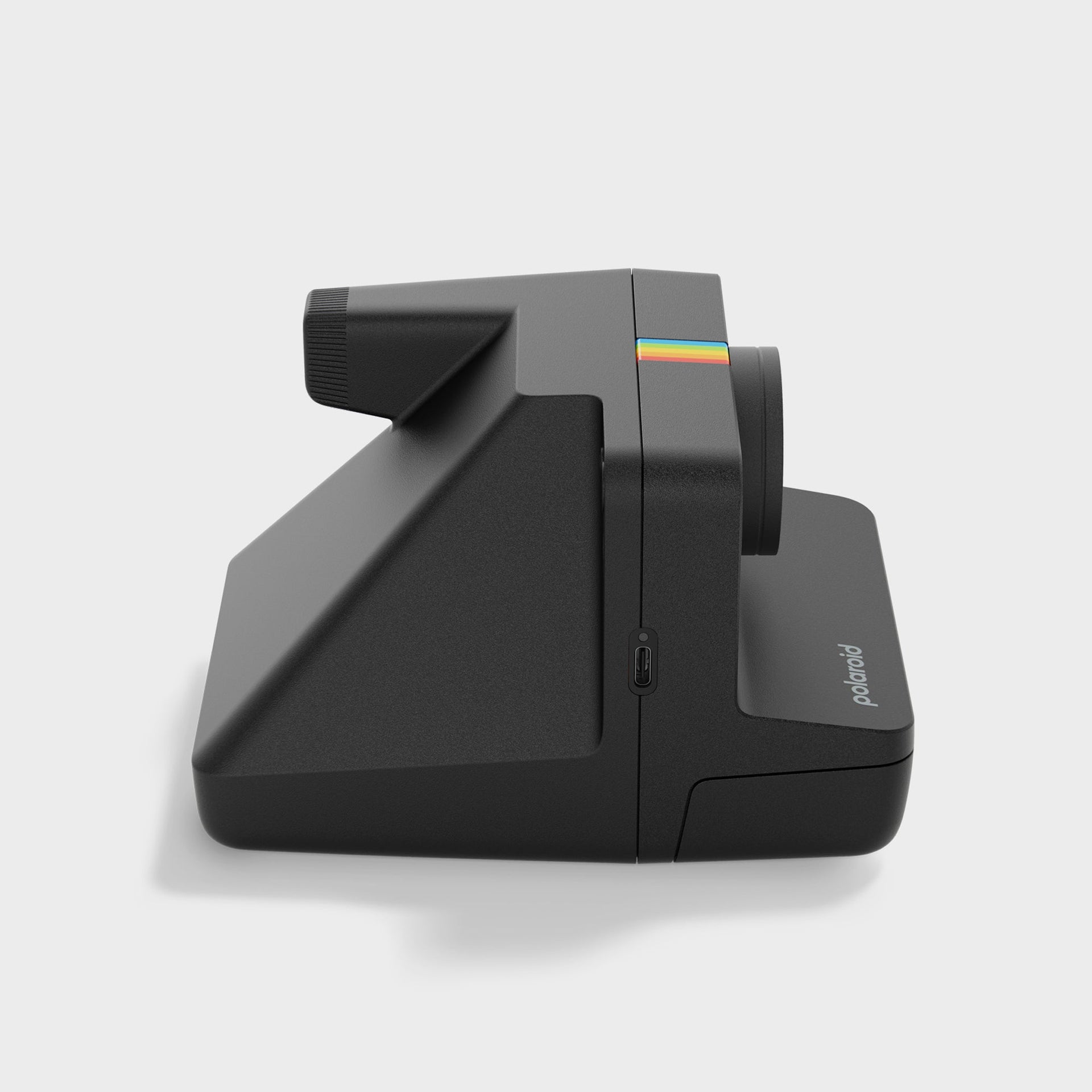Polaroid Now Gen 3 black instant camera in side profile showing its wedge shape and rainbow accent stripe