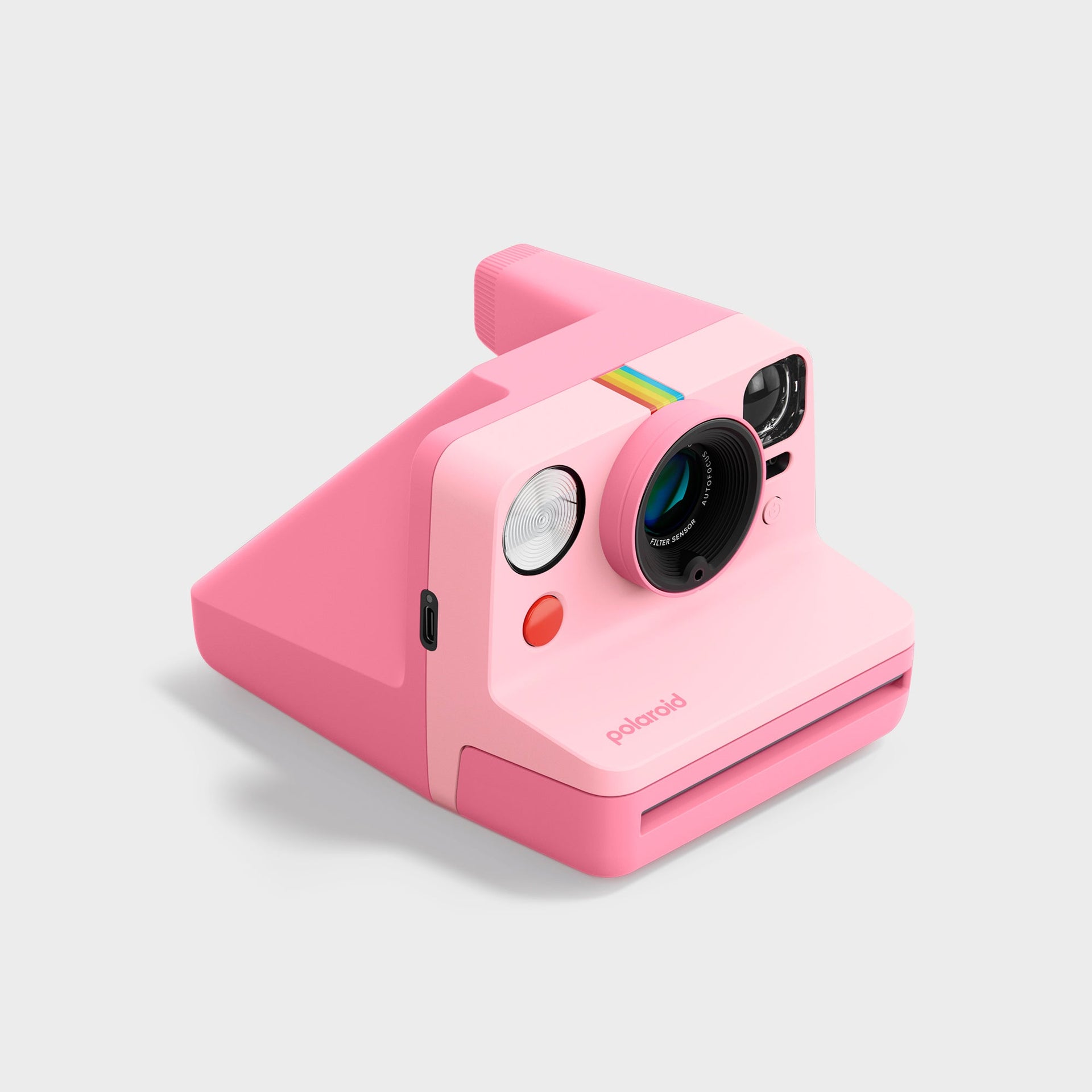 Polaroid Now Gen 3 pink instant camera at a three-quarter angle with USB-C port and red shutter visible