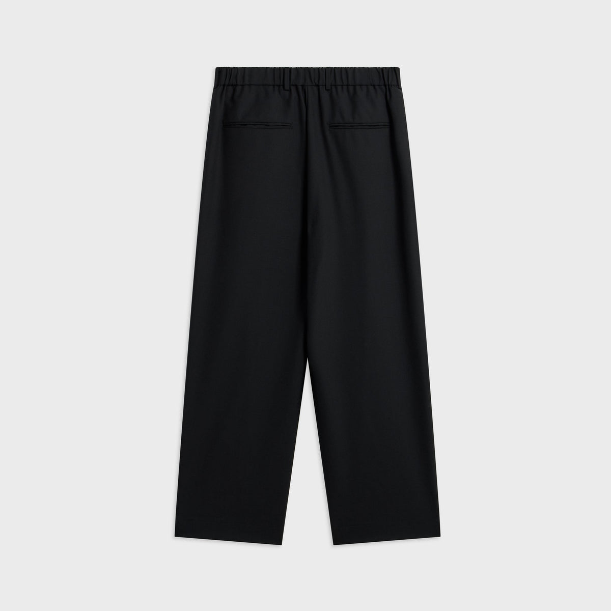 ATON Wool Tropical Loose Fit Pant in black, back view with elastic waist and welt back pockets