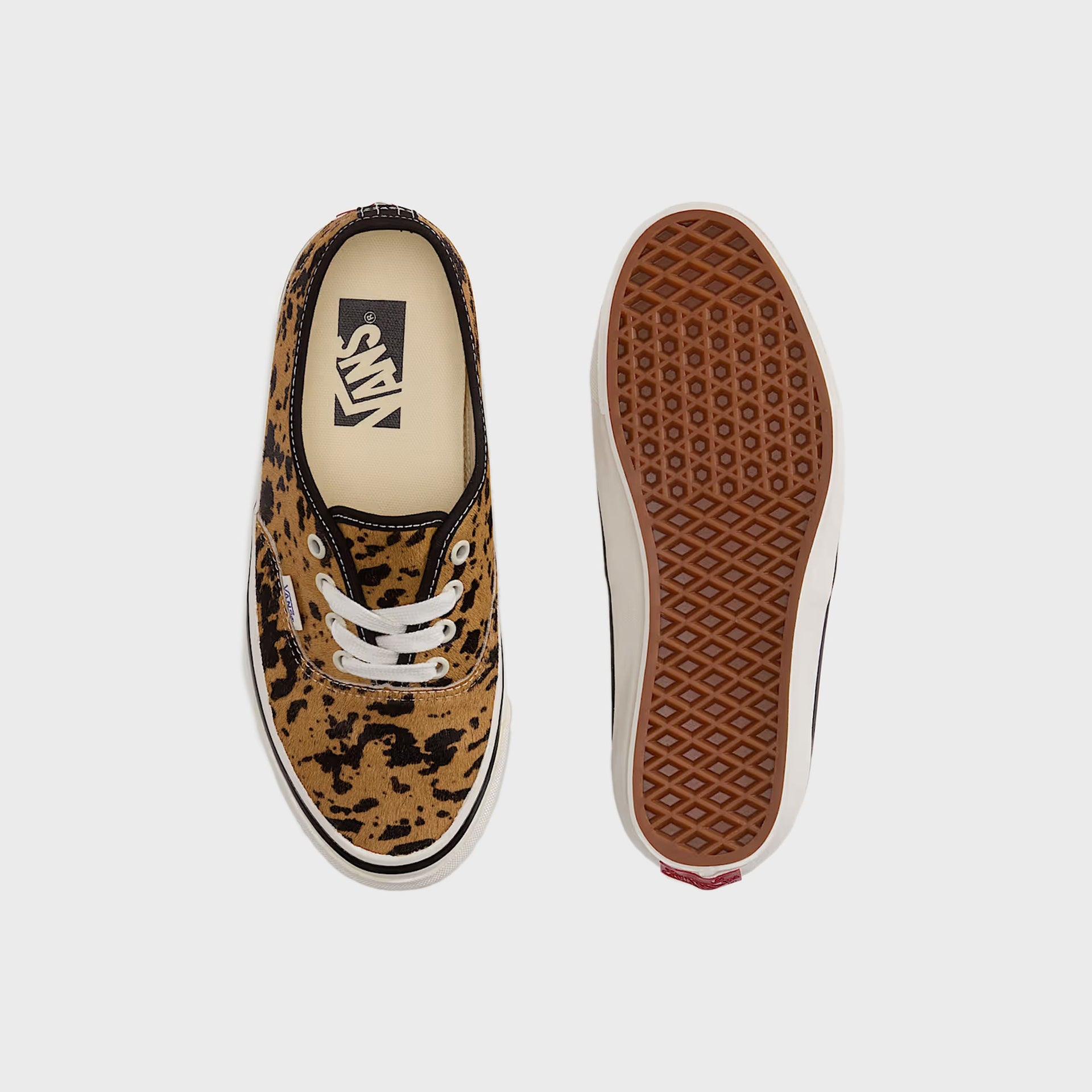 Pair of VANS LX Authentic 44 sneakers in cow-print calf hair, top-down view beside sole showing tan gum waffle tread