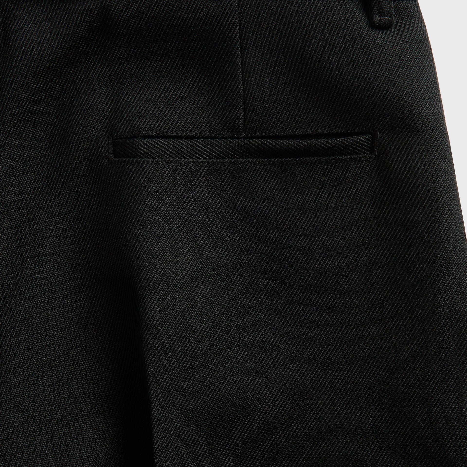 Stone Island cargo detail, black zip thigh pocket and compass badge patch on olive fabric