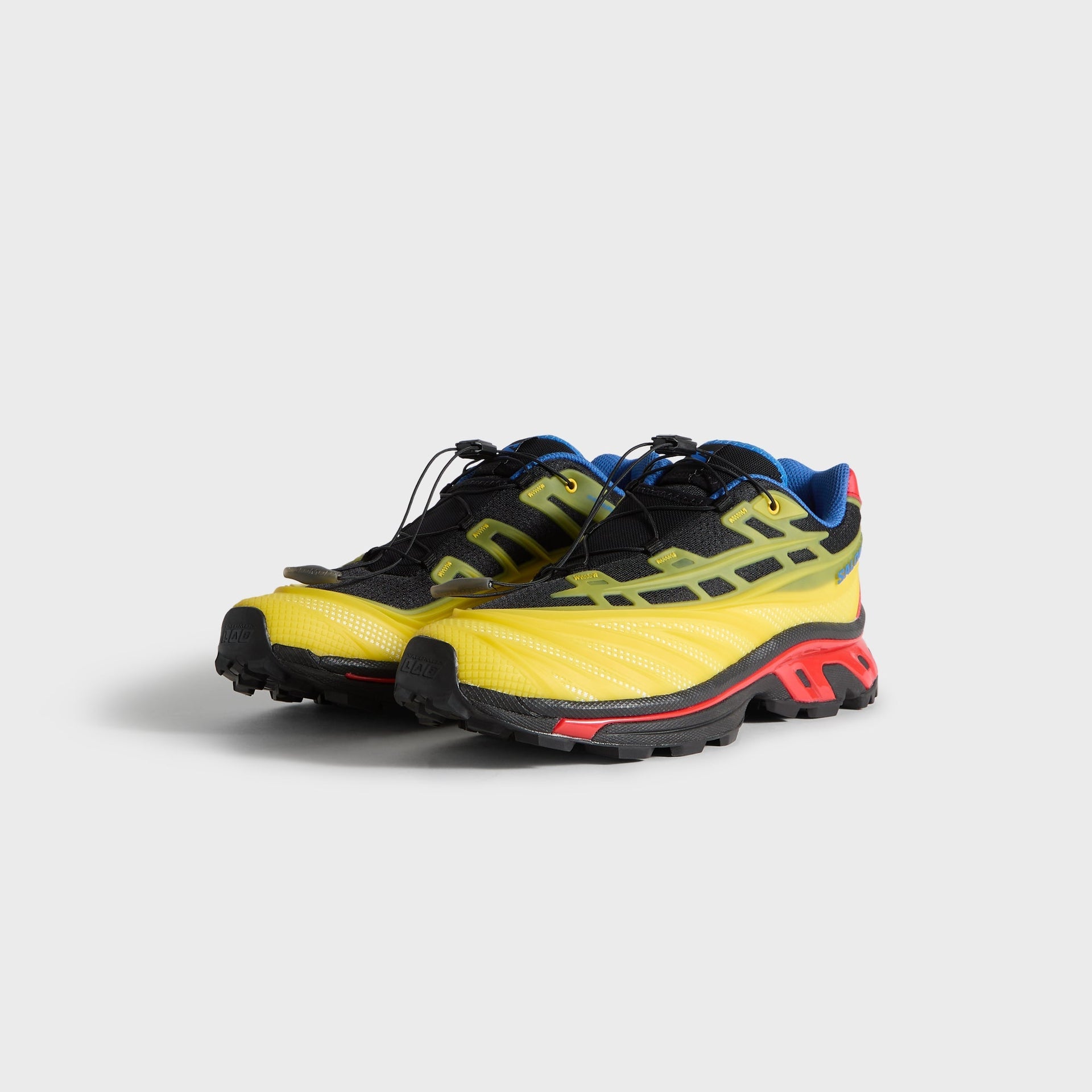 Kith for Salomon XT-EVO, front 3/4 angle of the pair, black quick-lace upper, yellow toe and red midsole