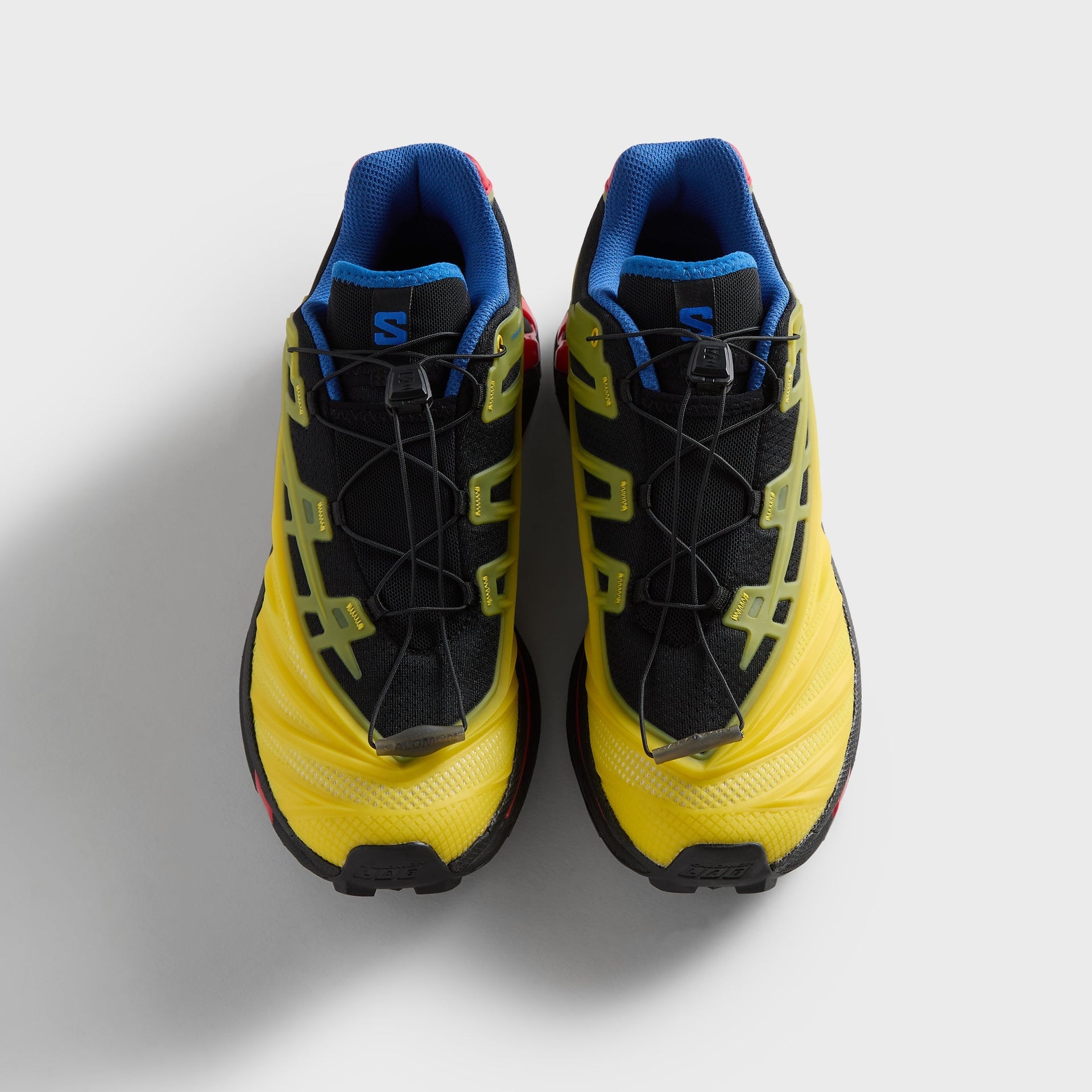 Kith for Salomon XT-EVO, top-down view of the pair, black quick-lace uppers with blue collars