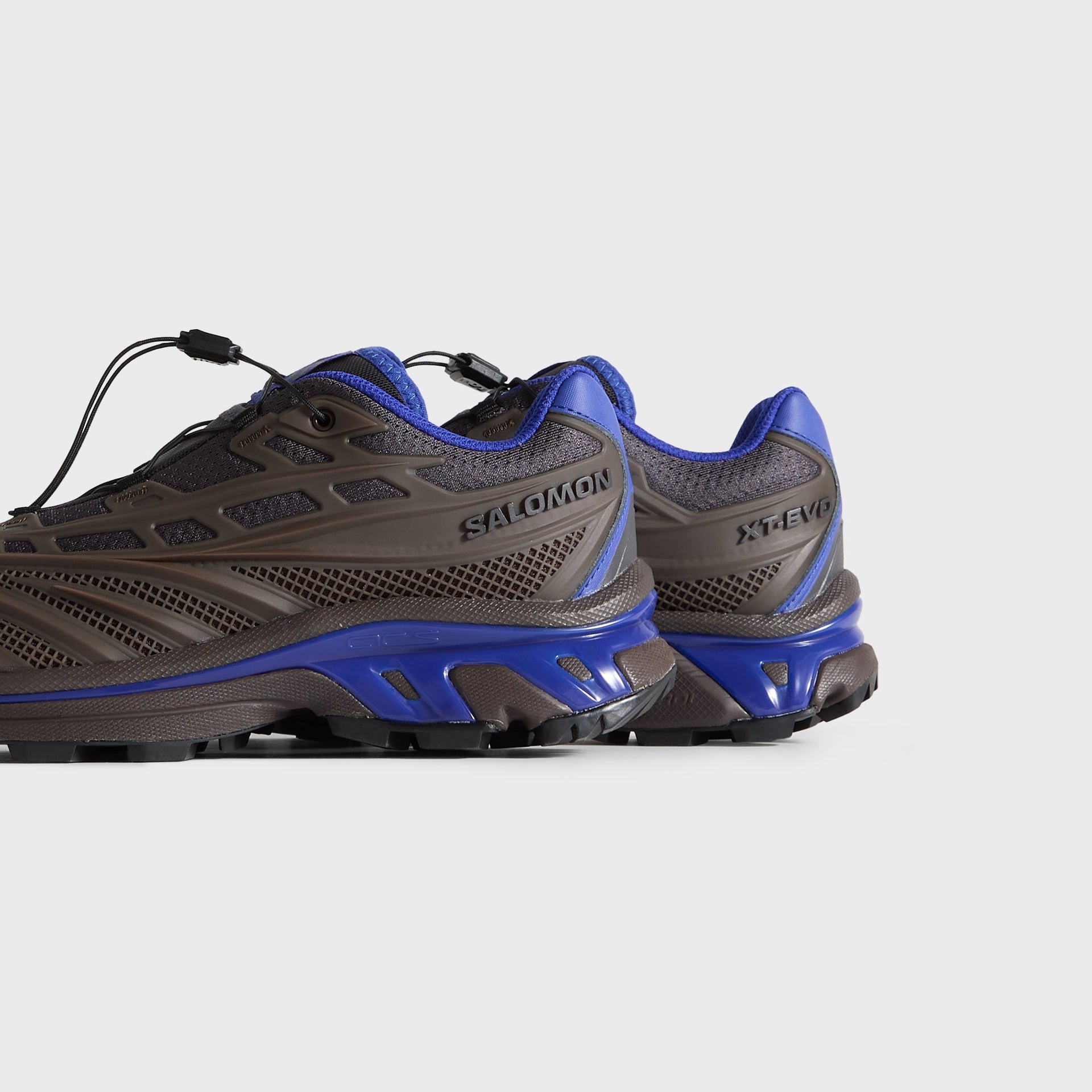 Kith for Salomon XT-EVO pair, rear three-quarter view showing Salomon heel branding and blue sole