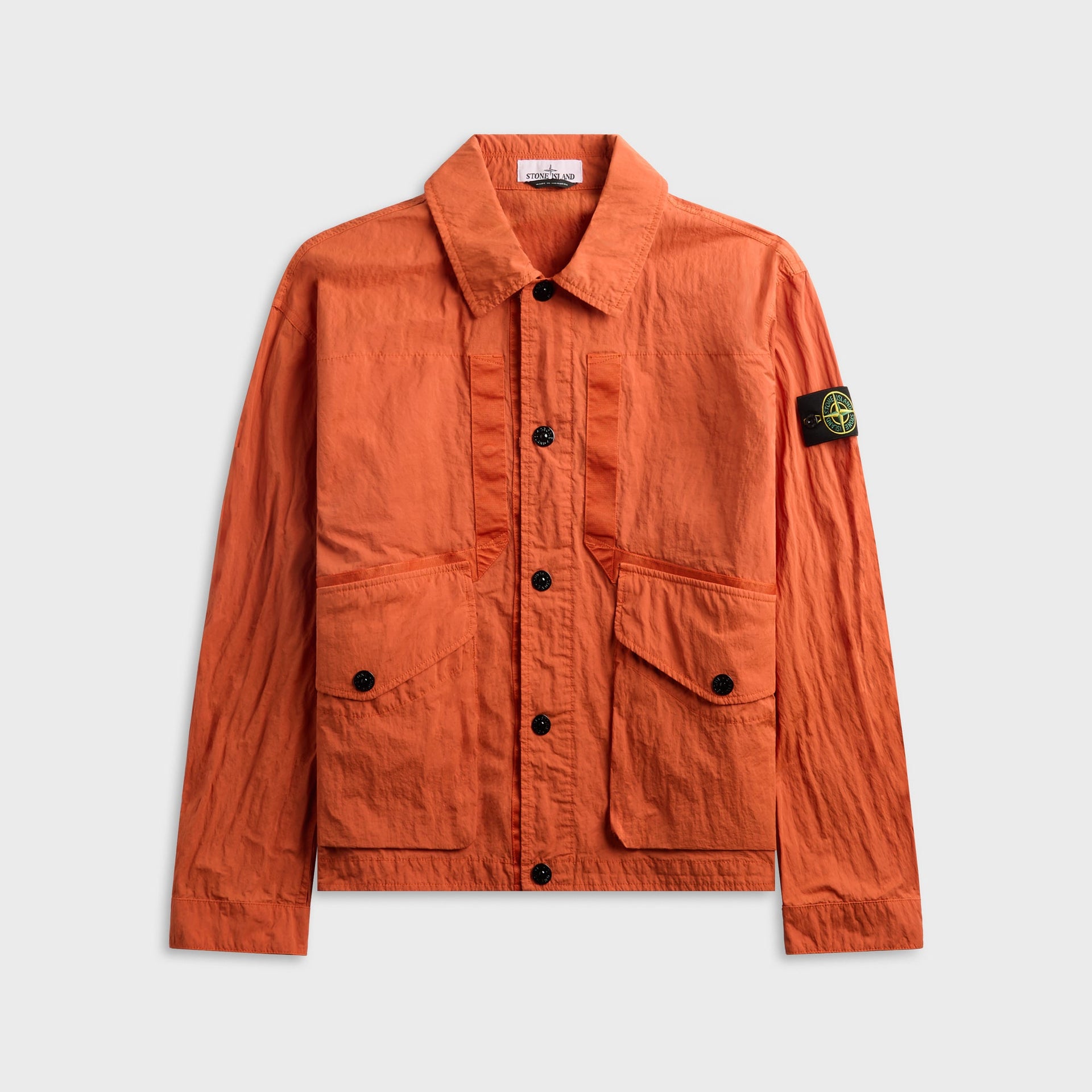 Stone Island Nylon-TC coach jacket in burnt orange, front view with spread collar, patch pockets and compass badge