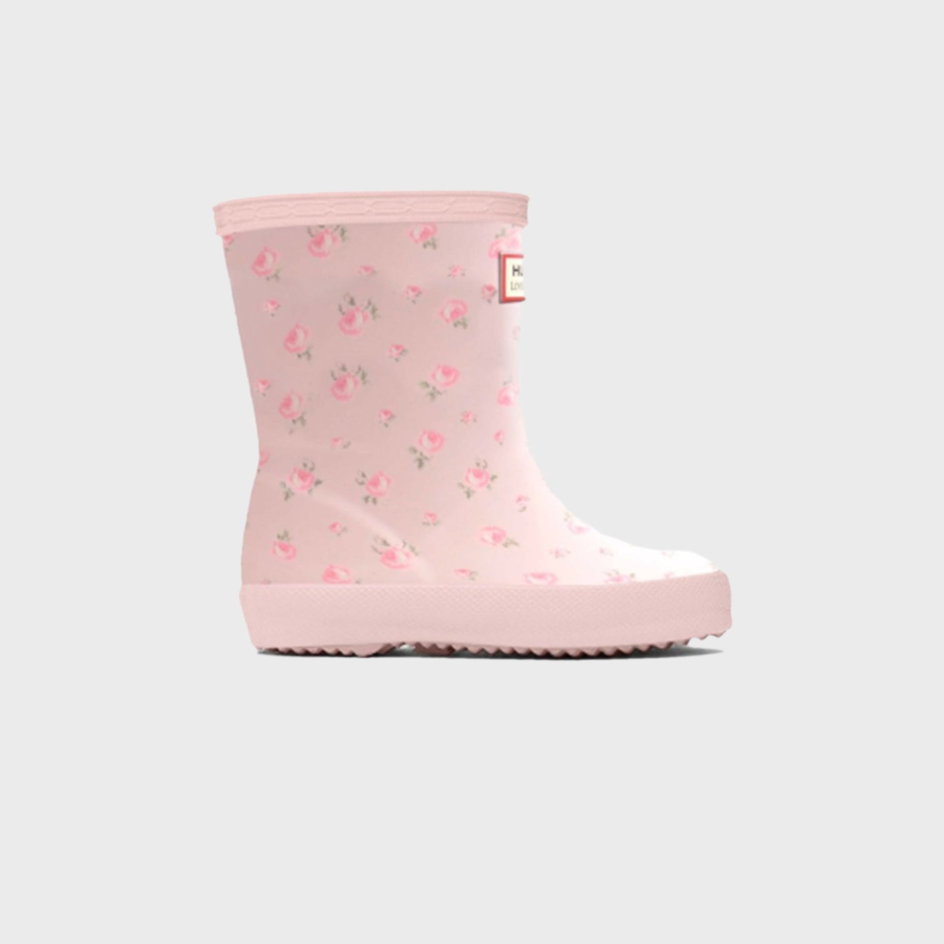 Hunter x LoveShackFancy kids First Classic rain boot in pale pink with an allover pink rose ditsy floral print, side view