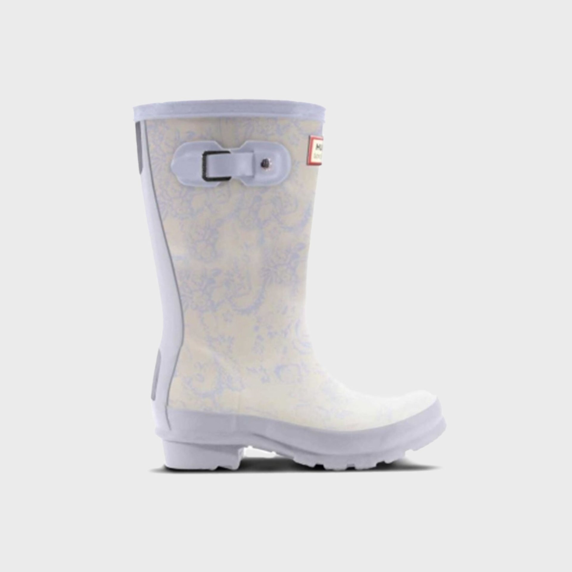 Hunter x LoveShackFancy kids Original rain boot in cream with a soft blue toile floral print and lilac sole, side view