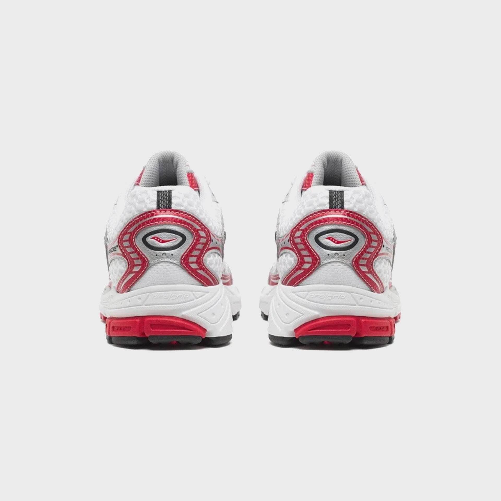 Pair of Saucony Progrid Ride 1 running shoes, rear heel view with red swoosh medallion and ProGrid text