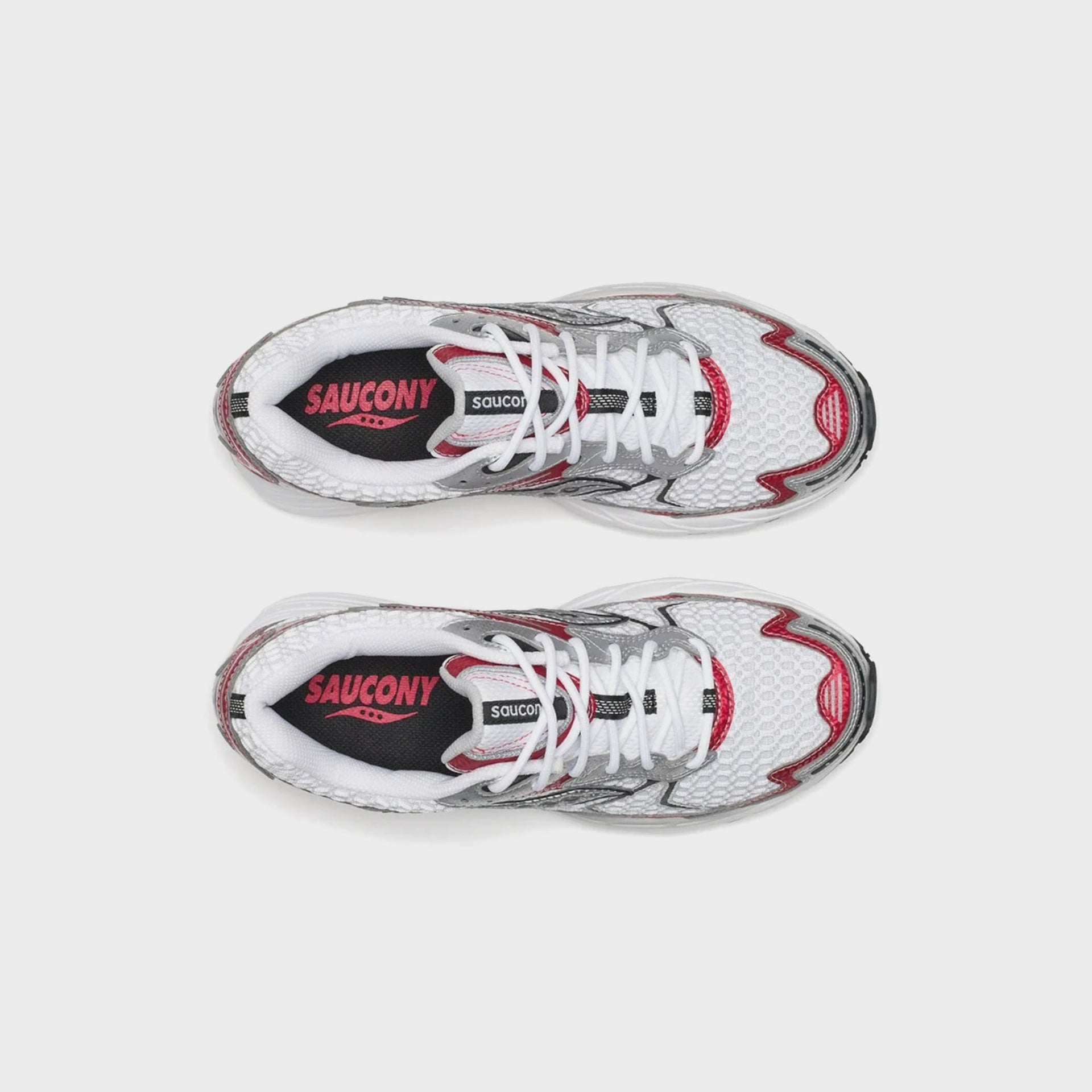Pair of Saucony Progrid Ride 1 running shoes, top-down view showing pink Saucony branding on black tongues