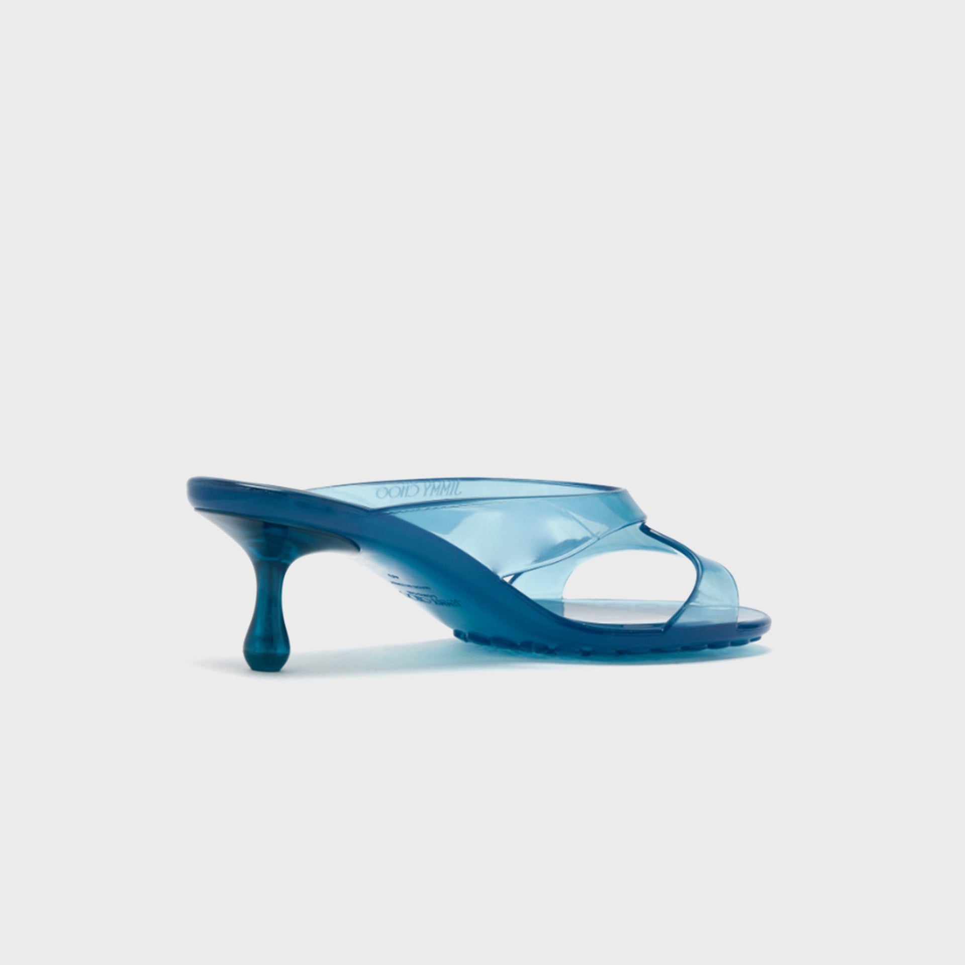 Jimmy Choo Jelly Drop 50 mule sandal in translucent light lagoon blue jelly, medial view showing Jimmy Choo branding on footbed
