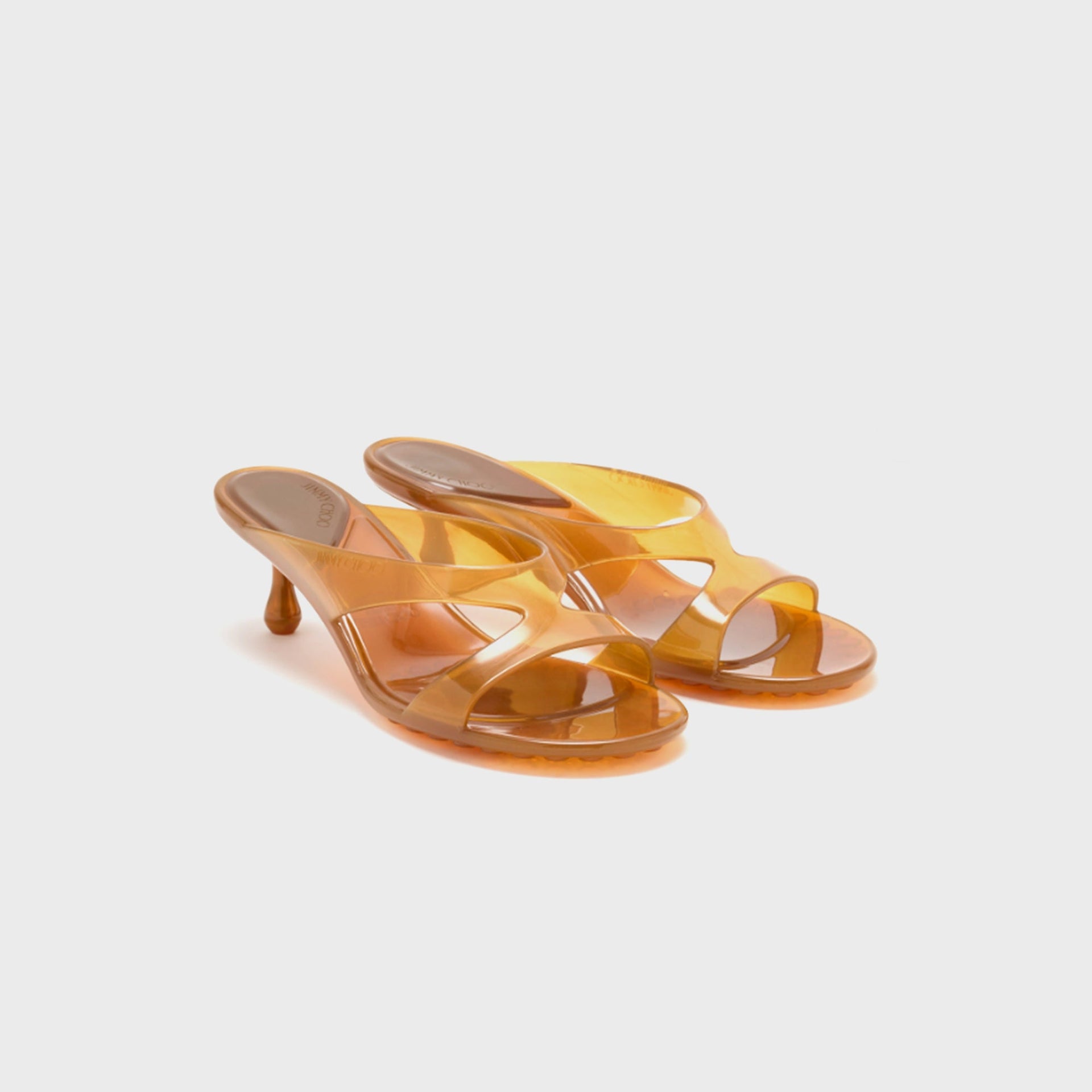 Pair of Jimmy Choo Jelly Drop 50 mule sandals in translucent amber jelly, front three-quarter view