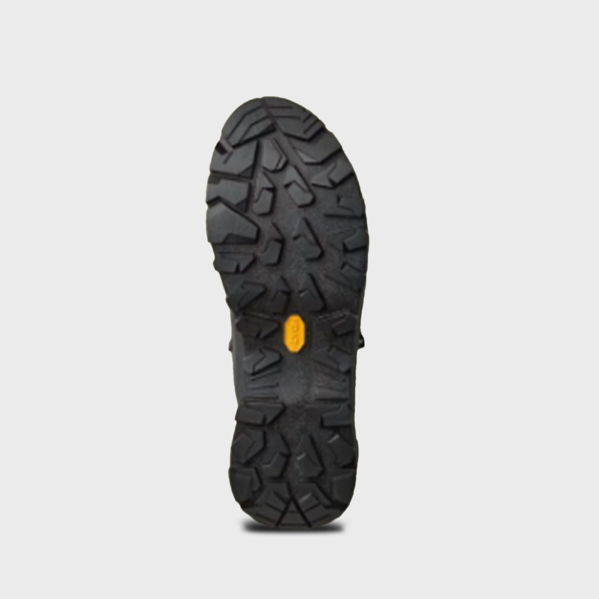 Arc'teryx Konseal Trek mid boot outsole showing black Vibram lug tread with yellow logo tab