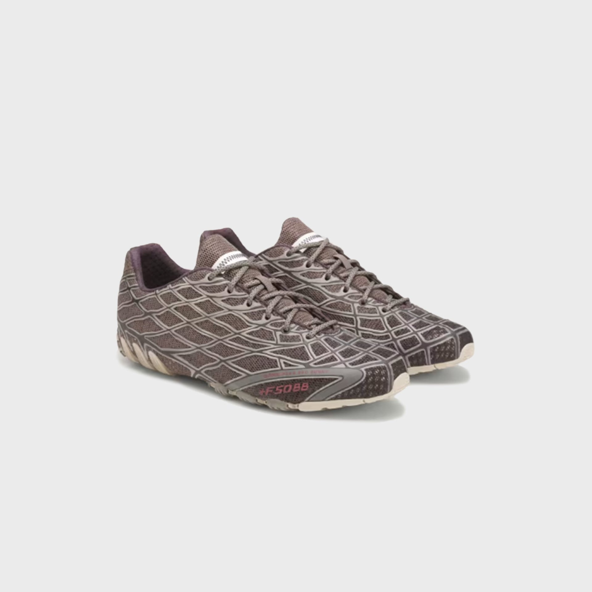 Pair of adidas x Bad Bunny F50 Ghost Sprint sneakers in grey-taupe mesh, angled three-quarter view with cream cleated soles