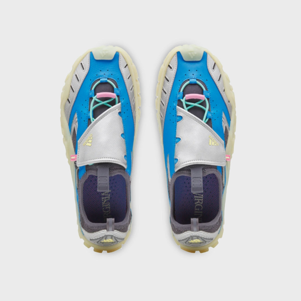 adidas x Pharrell Williams Water Moc pair, top-down view of slip-on silhouette with teal laces and silver metallic overlay