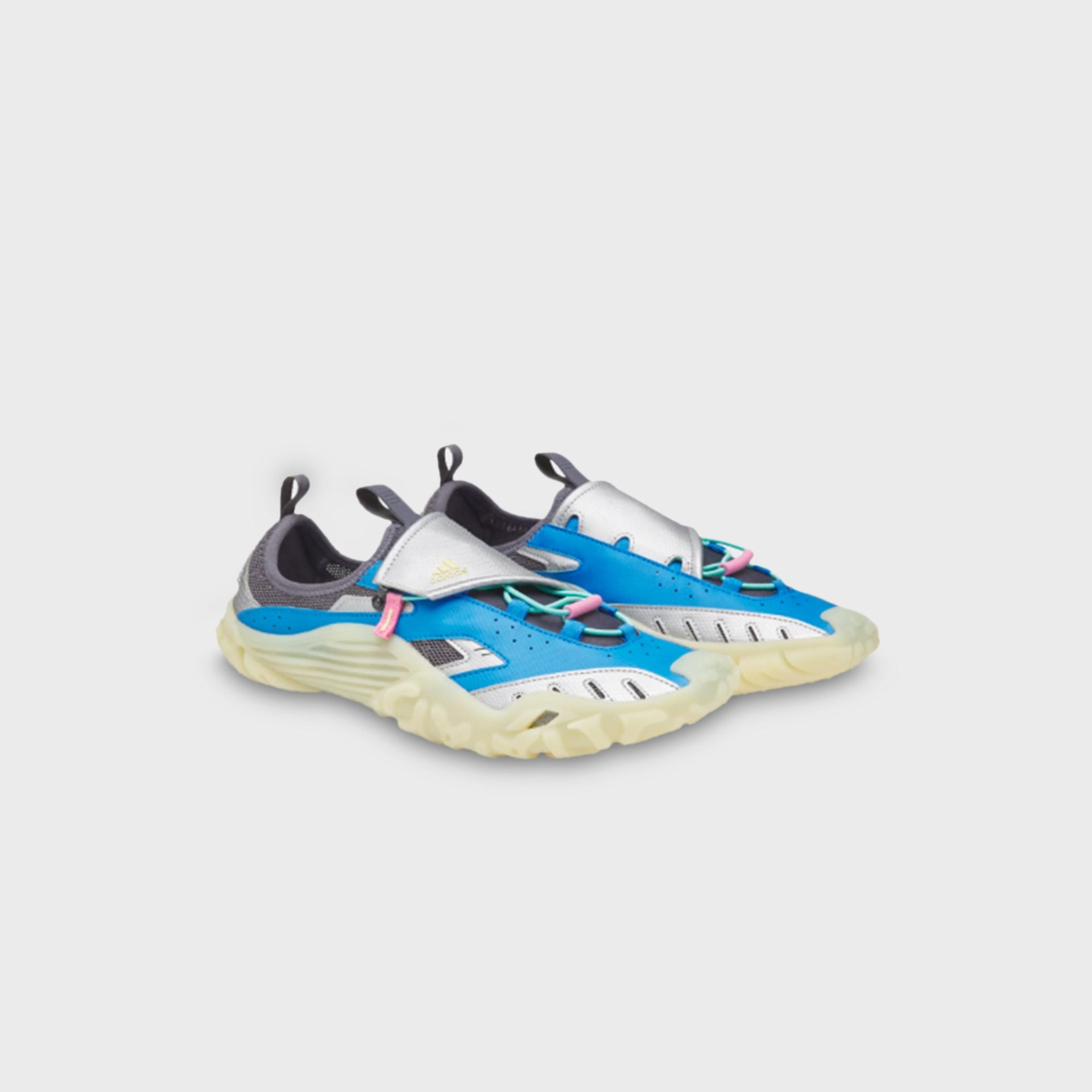 adidas x Pharrell Williams Water Moc pair, angled front view highlighting silver metallic toe cage and blue upper with pink lace toggle