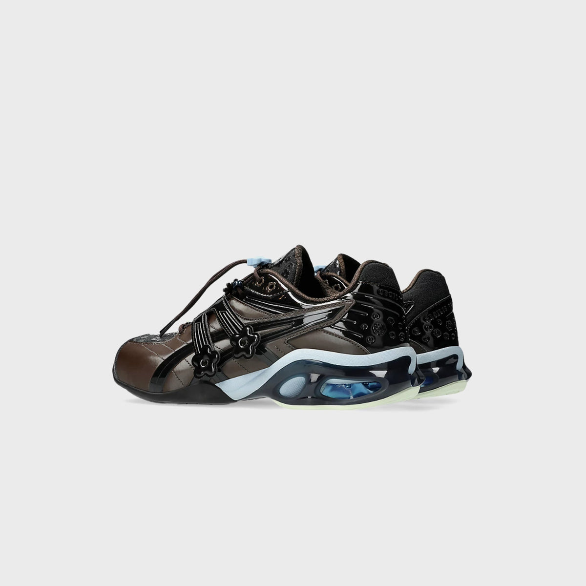 Rear three-quarter view of ASICS x Cecilie Bahnsen GEL-KINETIC FR pair in black coffee with pale blue midsole trim