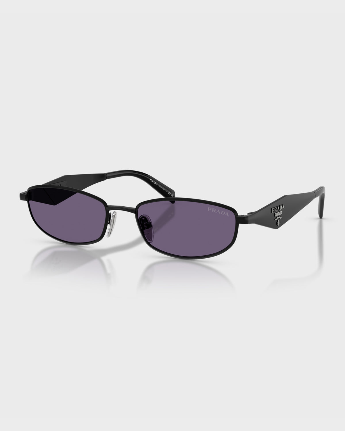 Prada women's slim oval sunglasses with black metal frame, purple tinted lenses and triangle logo temples, angled view