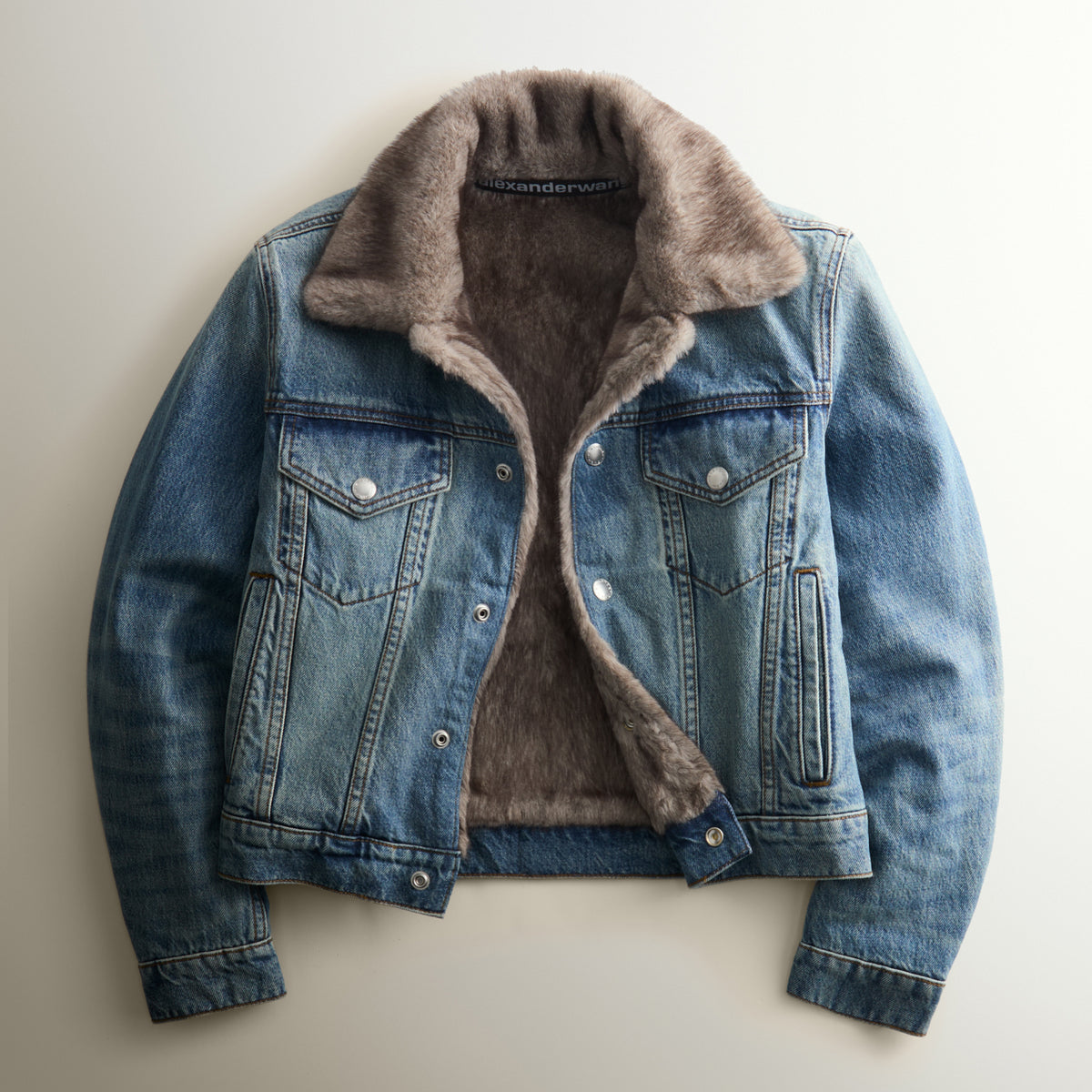 Alexander Wang women's blue washed denim trucker jacket with faux-fur shearling collar and lining, open front, flat view