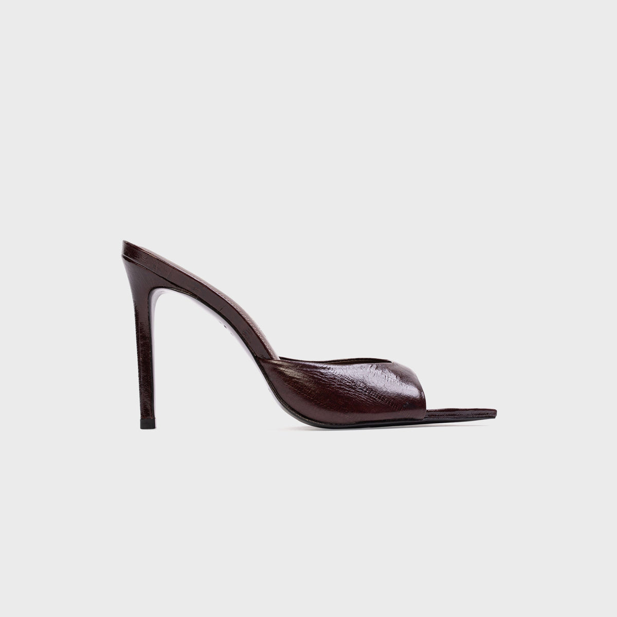 Black Suede Studio Brea Mule in Brown Eel (dark brown embossed leather), side profile with pointed toe and stiletto heel