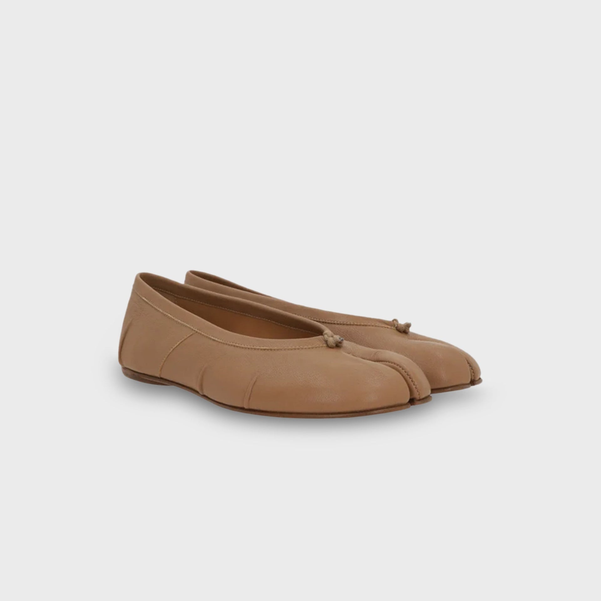 Pair of Maison Margiela WMNS Tabi ballerina flats in nude tan leather, front three-quarter view