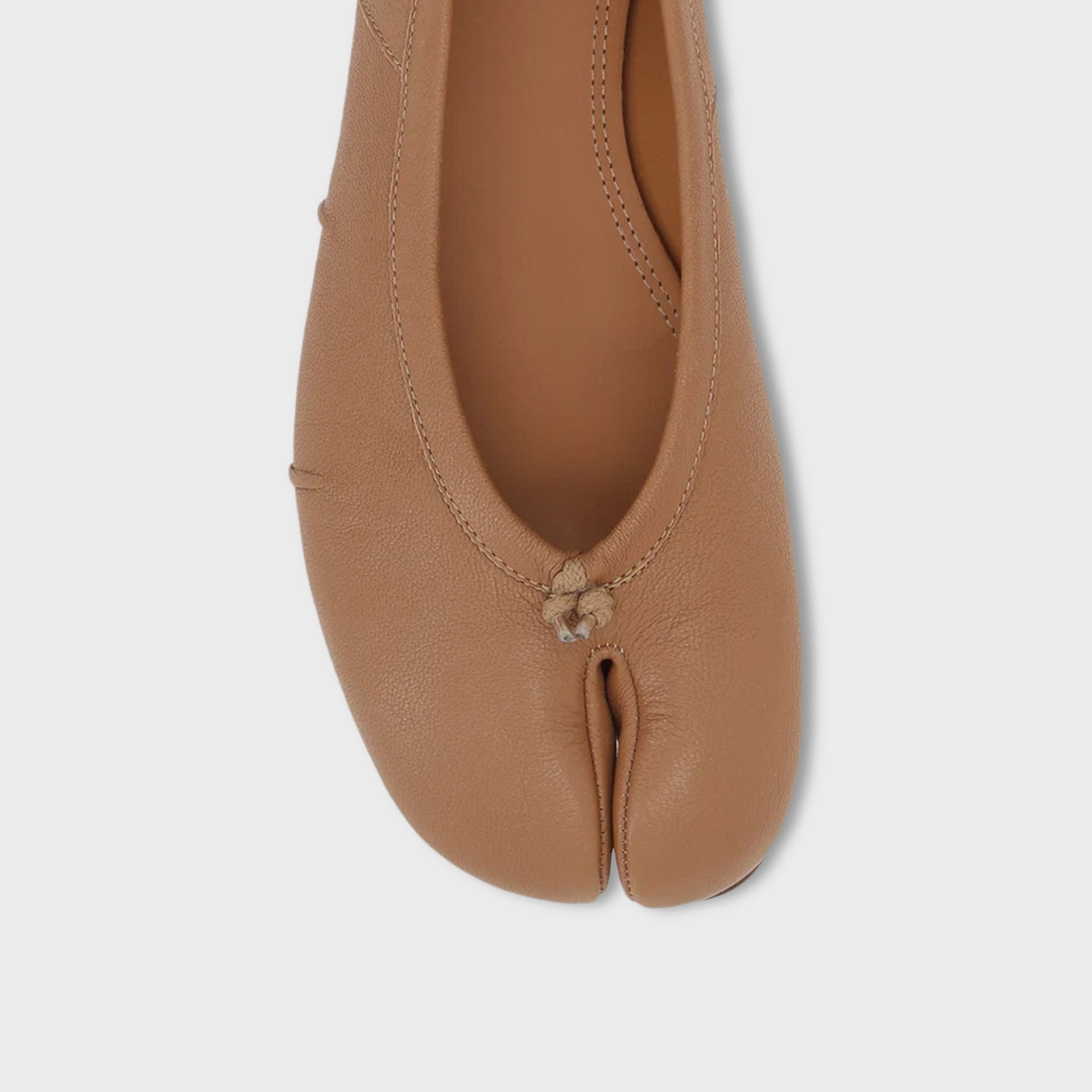 Maison Margiela WMNS Tabi ballerina flats in nude tan leather, top-down close-up of the split-toe seam and lace knot