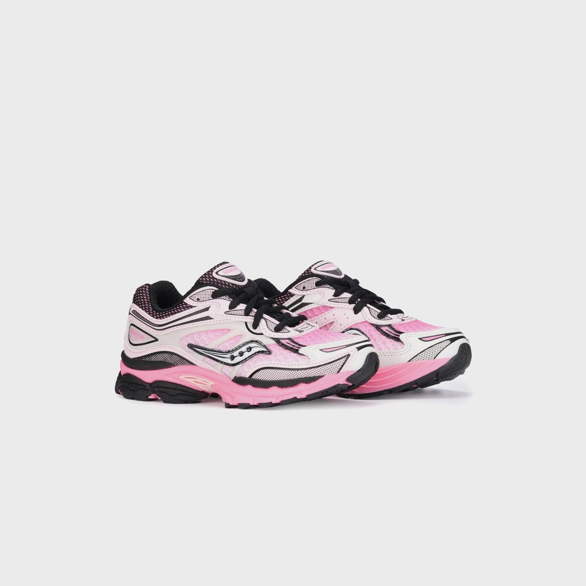 Saucony GS Omni 9 KDZ sneakers, angled front three-quarter view of the pink and white pair