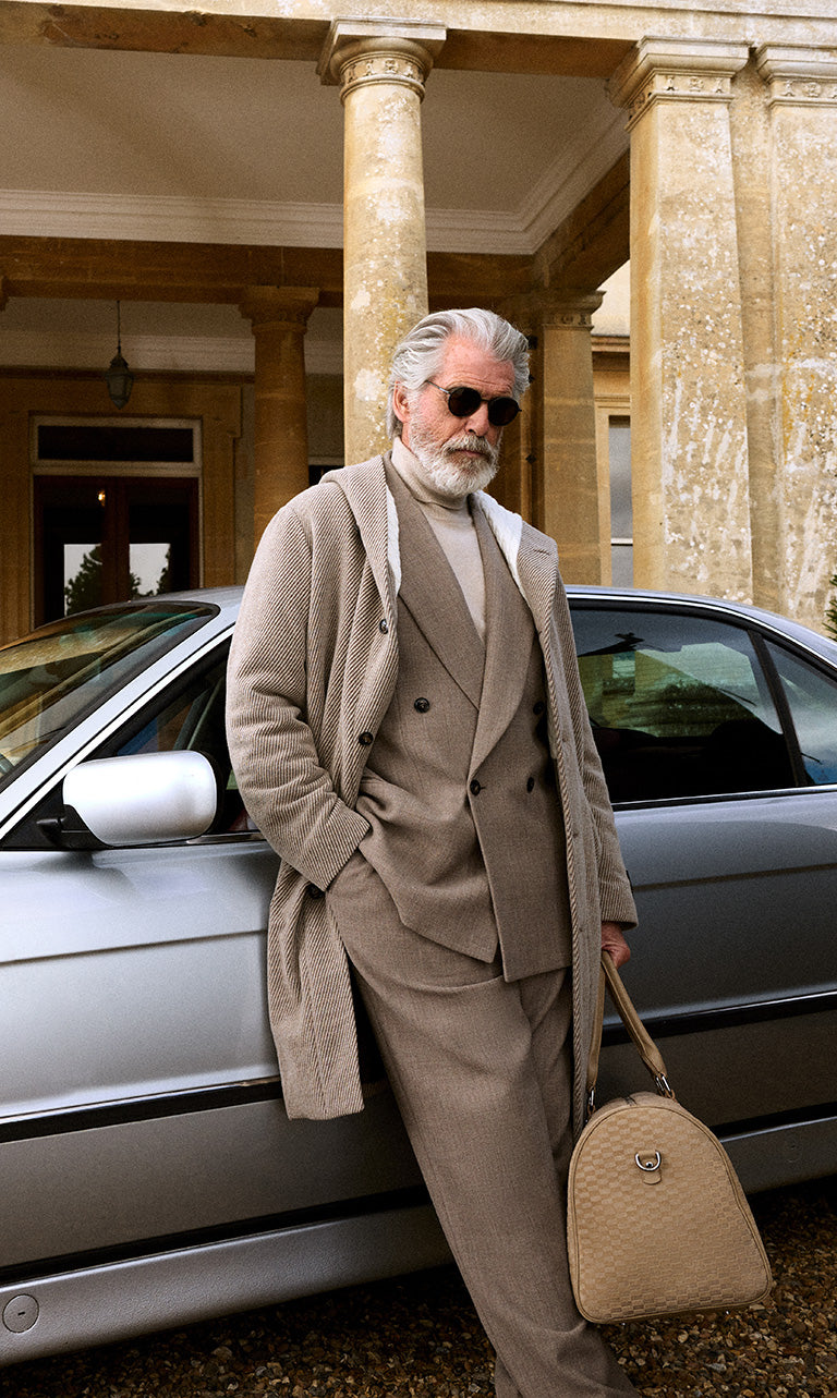 
        Pierce Brosnan for Kith & Giorgio Armani wearing a suit.
      
