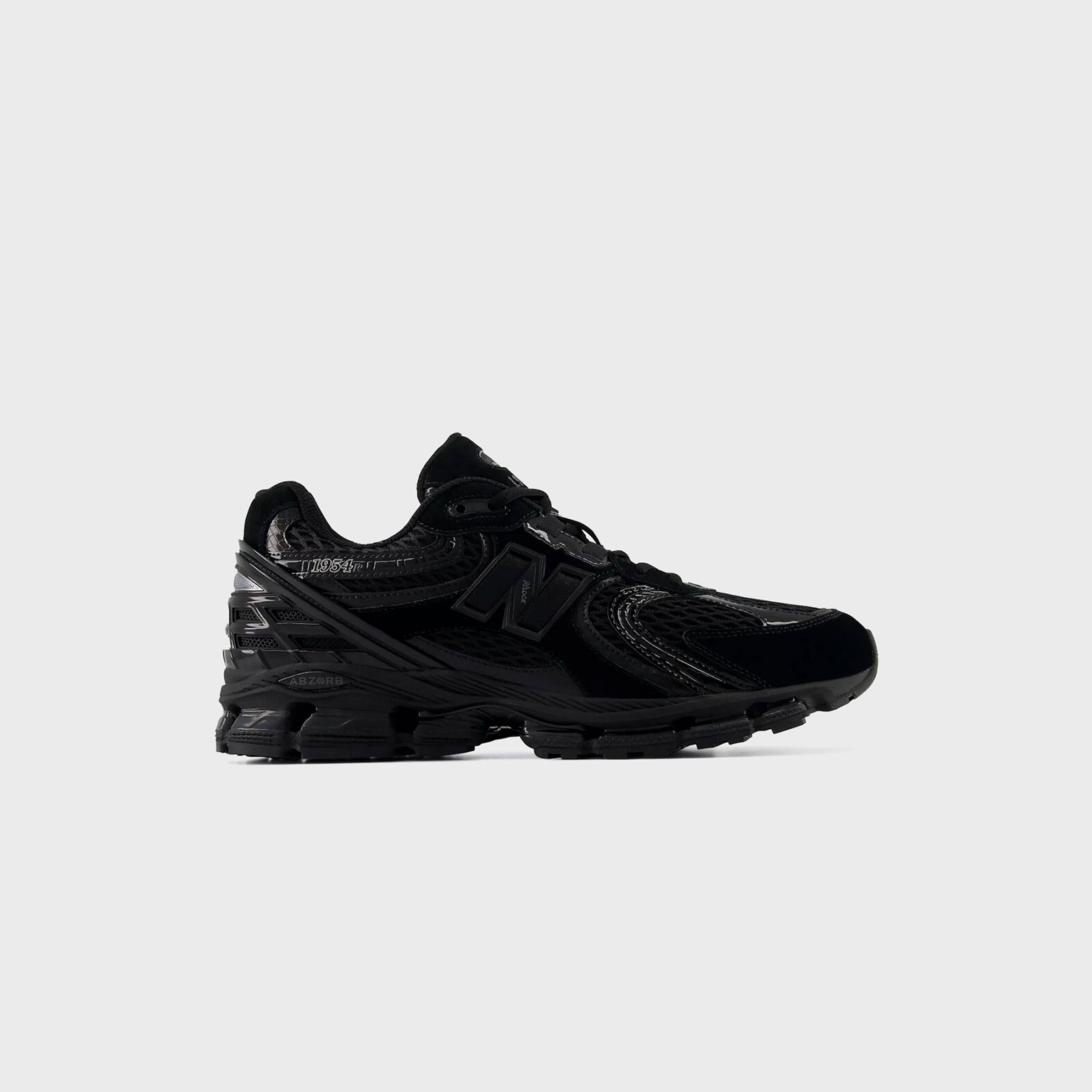 New Balance 1954R in all black with glossy overlays, mesh, tonal N logo and ABZORB midsole, lateral outer view