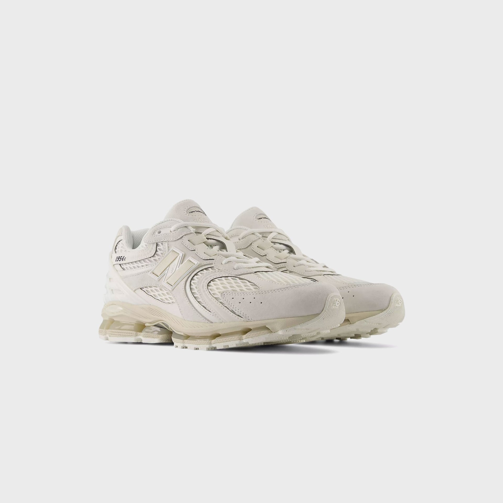 Pair of New Balance 1954R sneakers in tonal sea salt cream with suede and mesh, front three-quarter view