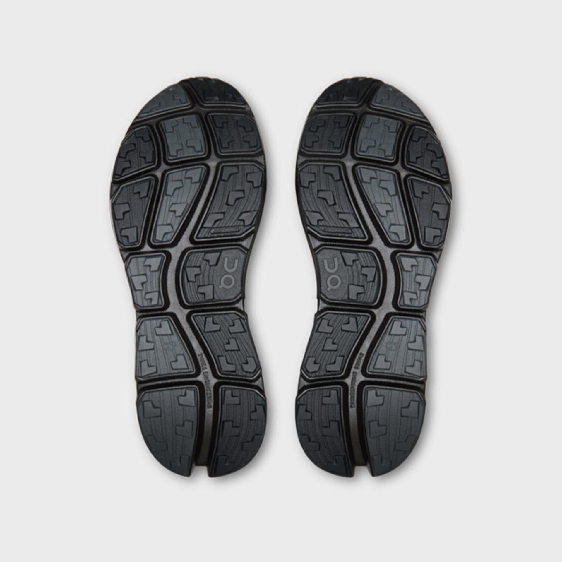 On x Post Archive Faction Cloudsoma sneaker in all-black, outsole tread view of pair