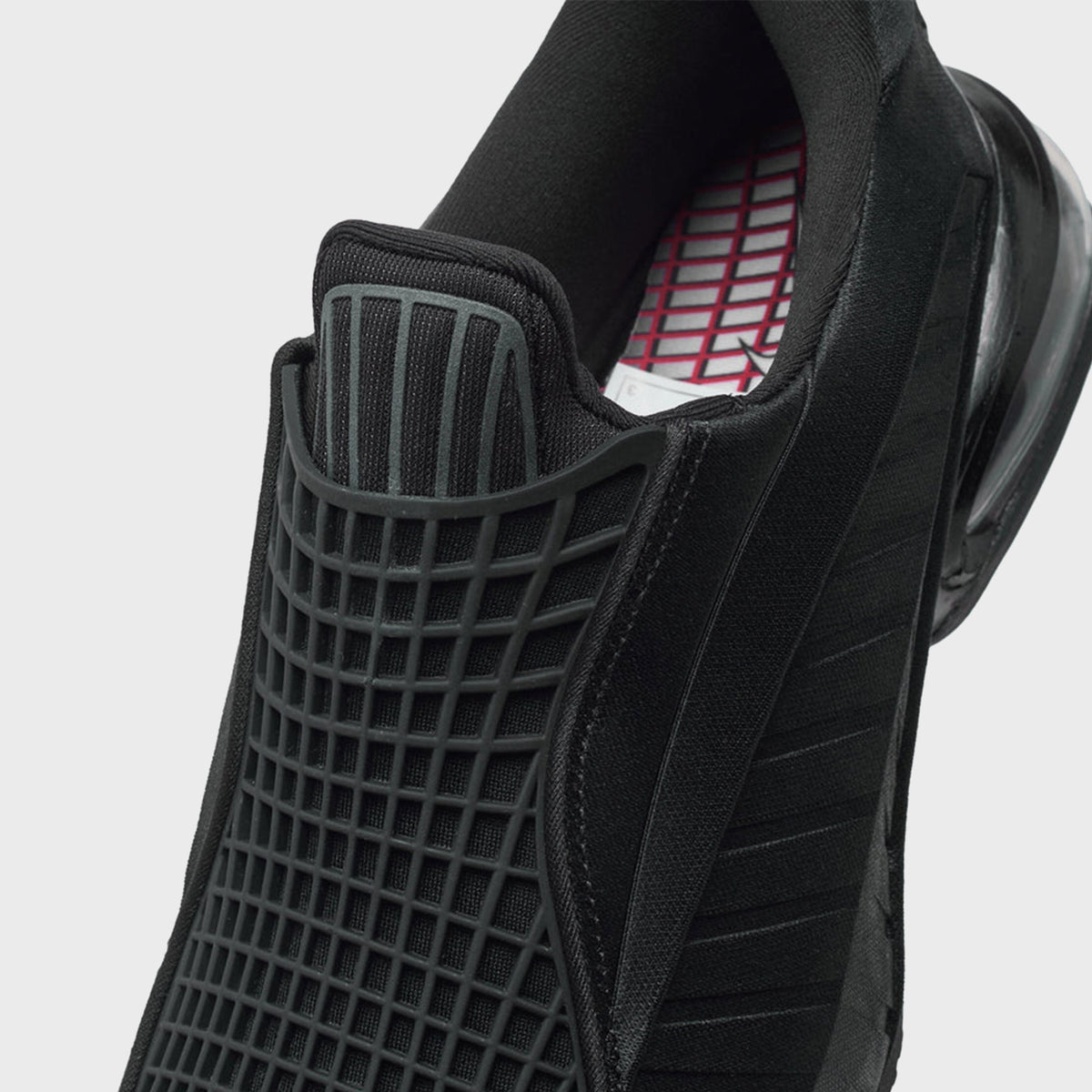 Nike WMNS Air Max Dolce Black / Sport Red close-up of grid-mesh tongue panel, heel pull tab and red patterned insole