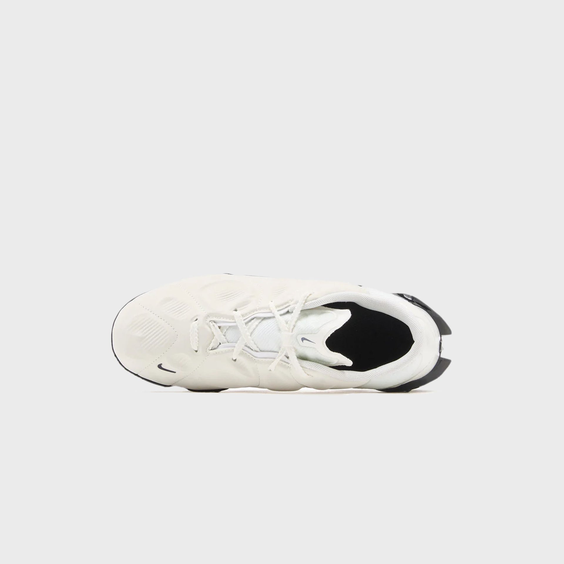 Overhead view of a Nike WMNS First Sight Mirage in sail showing the laces, sculpted panel upper and black lining