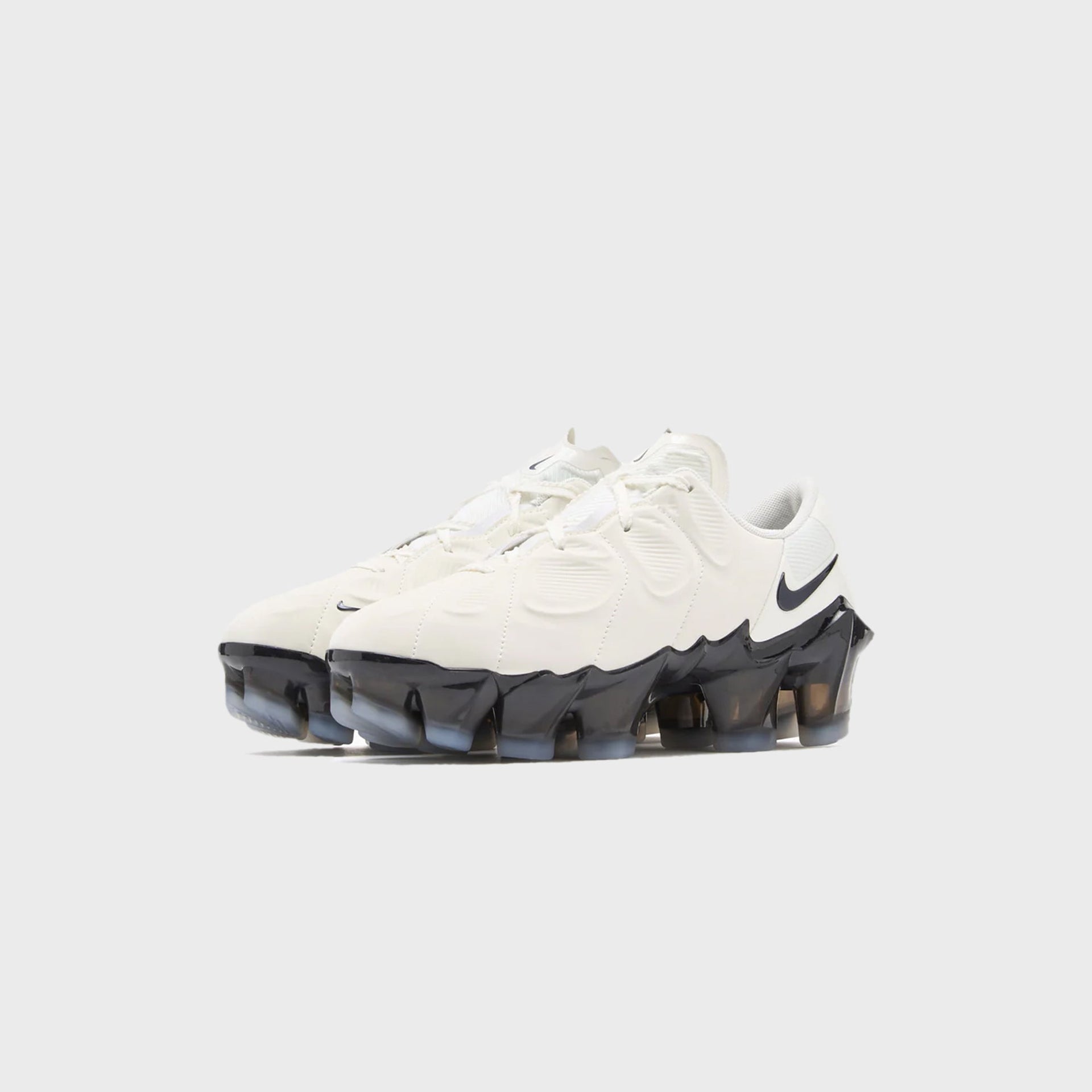 Pair of Nike WMNS First Sight Mirage sneakers in sail with translucent black VaporMax soles, front three-quarter view