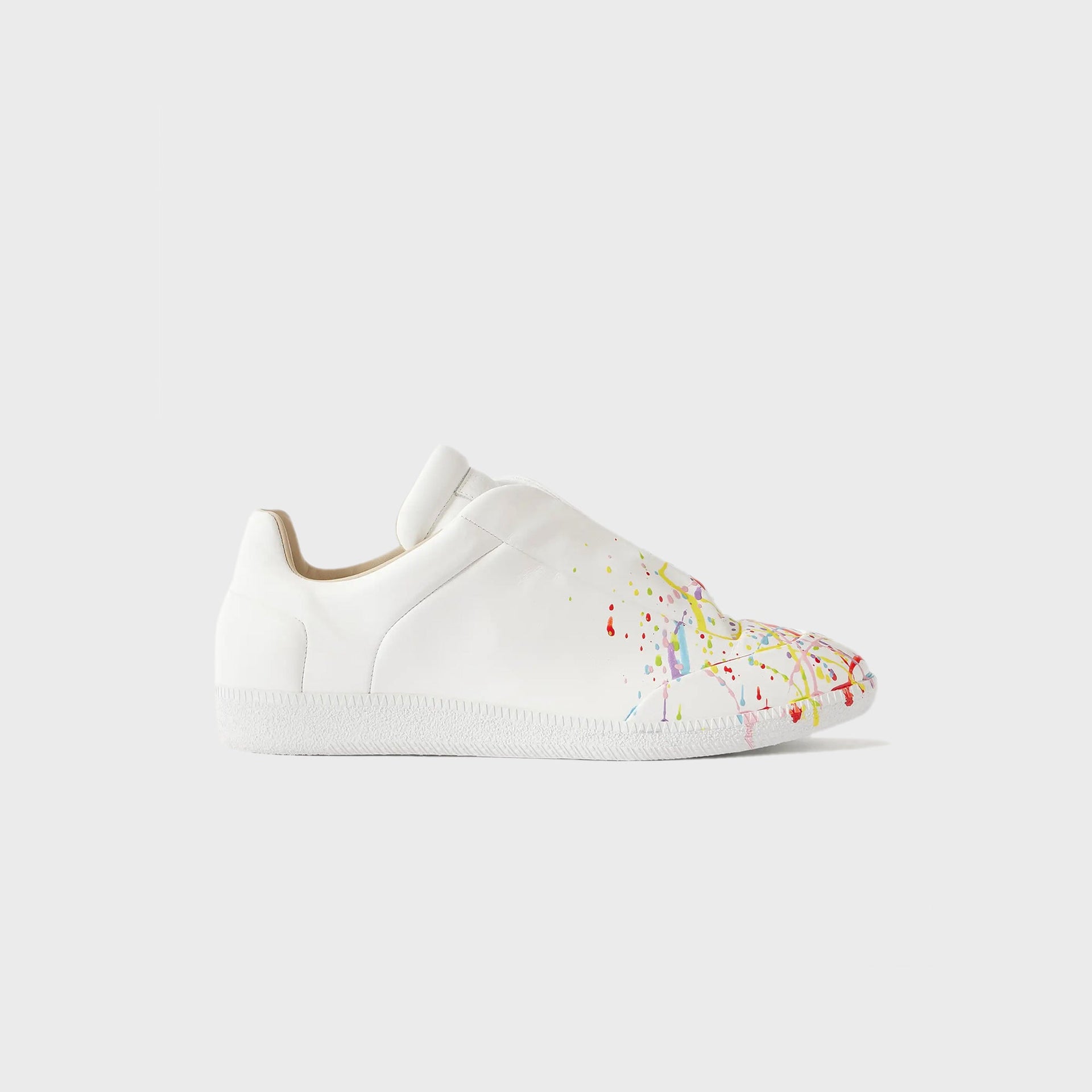 Maison Margiela Future low-top sneaker in white leather with multicolor paint-splatter toe, lateral view