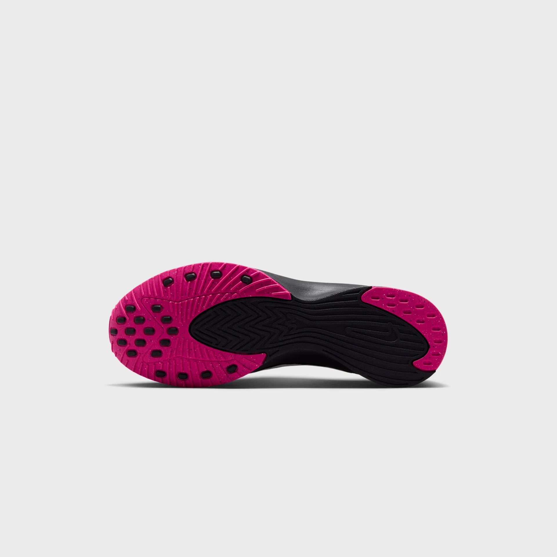 Nike WMNS Air Superfly Slip Neo SP outsole view showing pink prime traction lugs on a black rubber sole