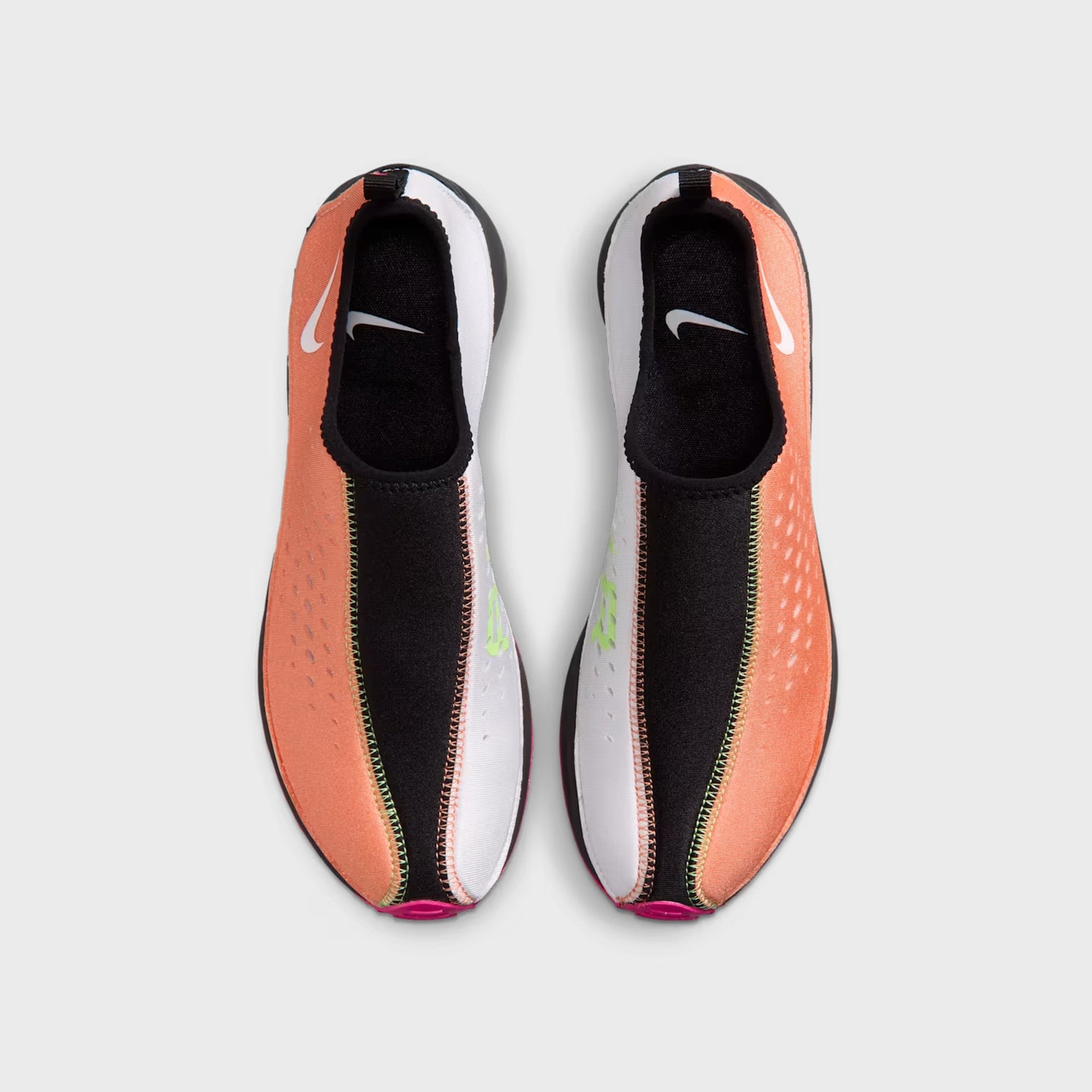 Pair of Nike WMNS Air Superfly Slip Neo SP slip-ons, top-down view showing orange lateral panels and white medial panels