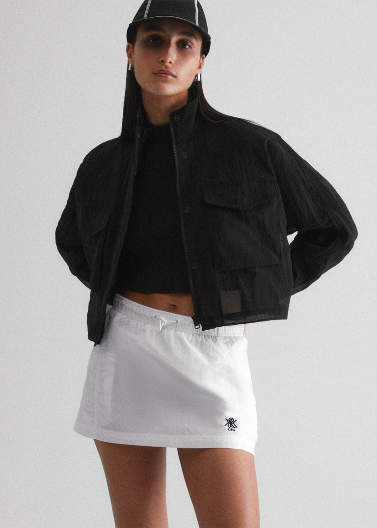 
            A hat, jacket, shirt, and skirt from Kith Women Spring 2024.
          
