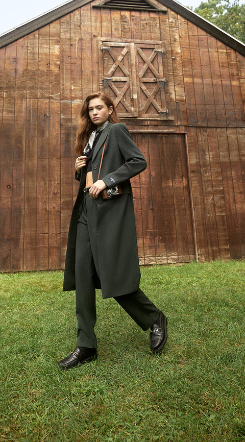
        A model wearing the Denali Suiting Duster and trousers from Kith Women Fall 2023.
      

